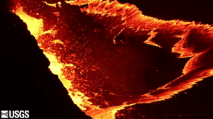 An animated GIF showing sloshing, splashing incandescent lava at night.