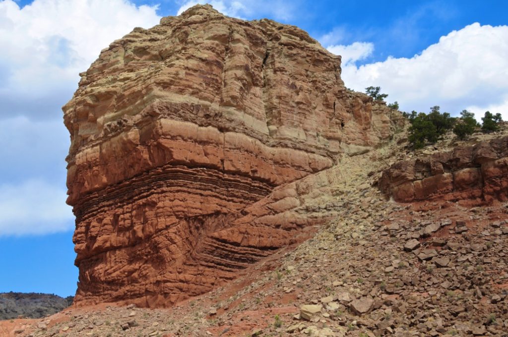 Ketobe Knob in the San Rafael Swell of Utah displays an example of a thrust fault. Ketobe Knob photo by Ron Schott CC BY-NC 4.0 International. From: https://www.flickr.com/photos/rschott/814080386/.