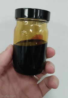 Animated GIF showing oil sloshing around inside a small bottle. 