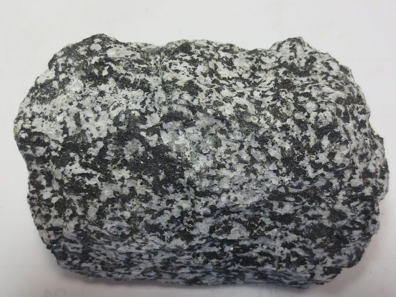 Rock with visible black and white crystals.