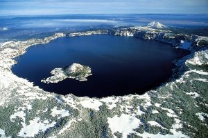 The mountain has a large hole in the center that is filled with the lake.